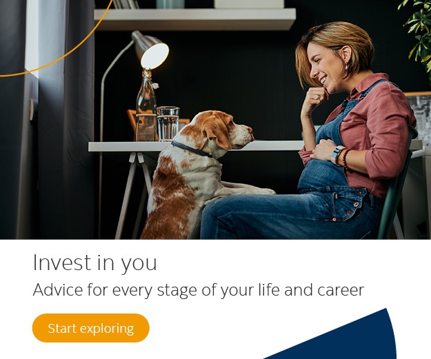 pregnant woman sitting at a desk with dog on her lap