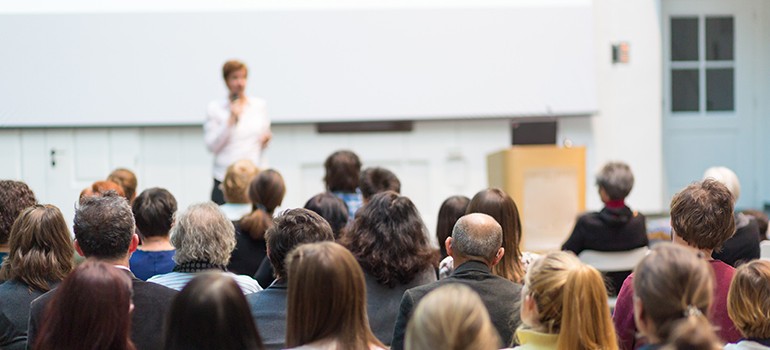 Teacher giving a lecture in an auditorium