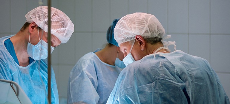 Specialist operating on a patient