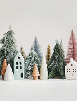 Miniature cozy village, ceramic houses, wooden and handmade Christmas trees