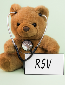 brown teddy bear wearing a stethoscope