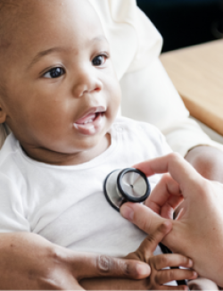 physician using a stethoscope during a baby examination